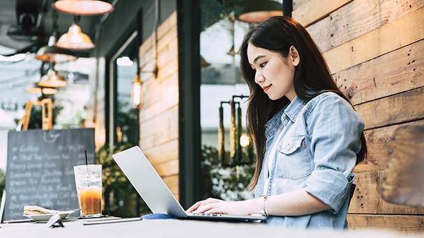 Woman on laptop at coffee shop.