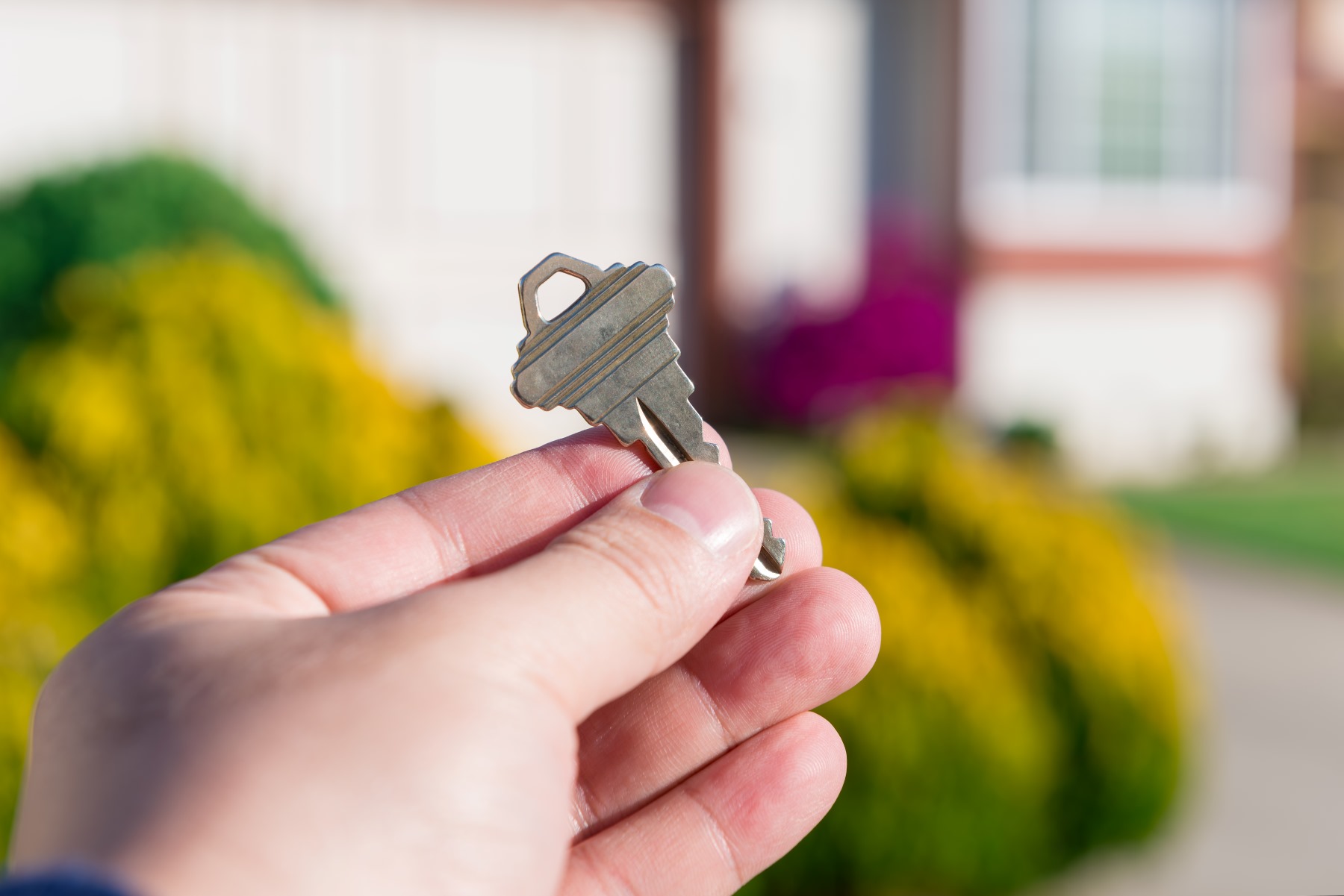 Closeup of a person's hand holding a key