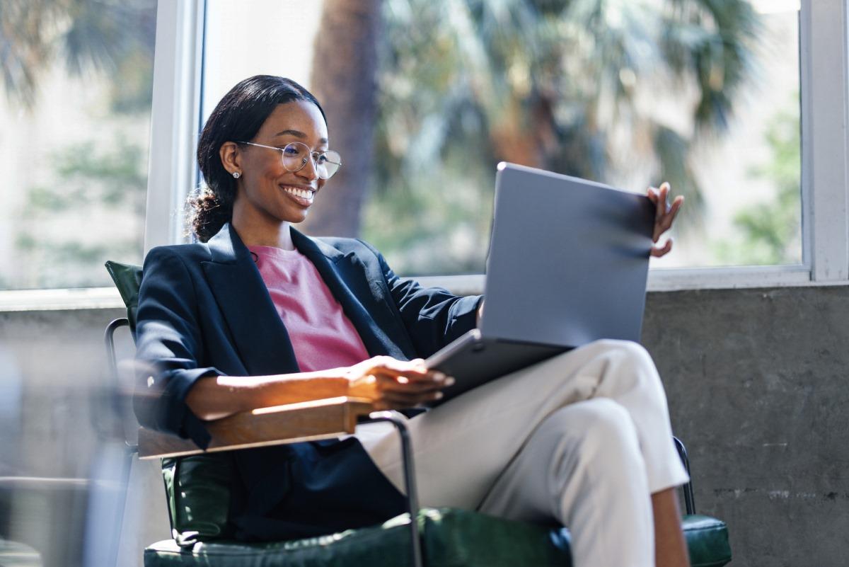 Woman sitting in chair with laptop