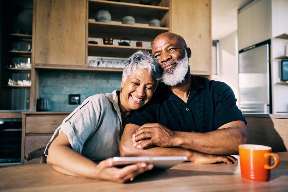 Couple hugging at table